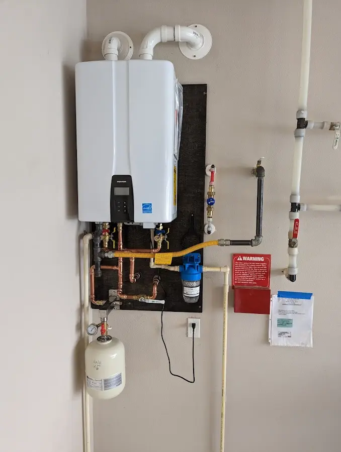 Professional plumber installing copper piping in a White Creek home